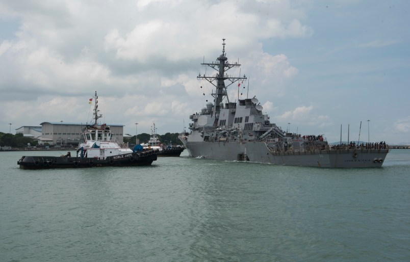 CHANGI NAVAL BASE, REPUBLIC OF SINGAPORE – Tugboats from Singapore assist the Guided-missile destroyer USS John S. McCain (DDG 56) as it steers towards Changi Naval Base, Republic of Singapore following a collision with the merchant vessel Alnic MC while underway east of the Straits of Malacca and Singapore on Aug. 21. Significant damage to the hull resulted in flooding to nearby compartments, including crew berthing, machinery, and communications rooms. Damage control efforts by the crew halted further flooding. The incident will be investigated. (U.S. Navy photo by Mass Communication Specialist 2nd Class Joshua Fulton/Released)