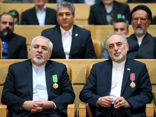 FILE-- In this file photo taken on Monday, Feb. 8, 2016, chief of Iran's Atomic Energy Organization Ali Akbar Salehi, right, sits next to Foreign Minister Mohammad Javad Zarif after being awarded medal of honor by President Hassan Rouhani during a ceremony in Tehran, Iran.  Iran's atomic chief warned Tuesday the Islamic Republic needs only five days to ramp up its uranium enrichment to 20 percent, a level at which the material could be used for a nuclear weapon. (AP Photo/Ebrahim Noroozi, File)