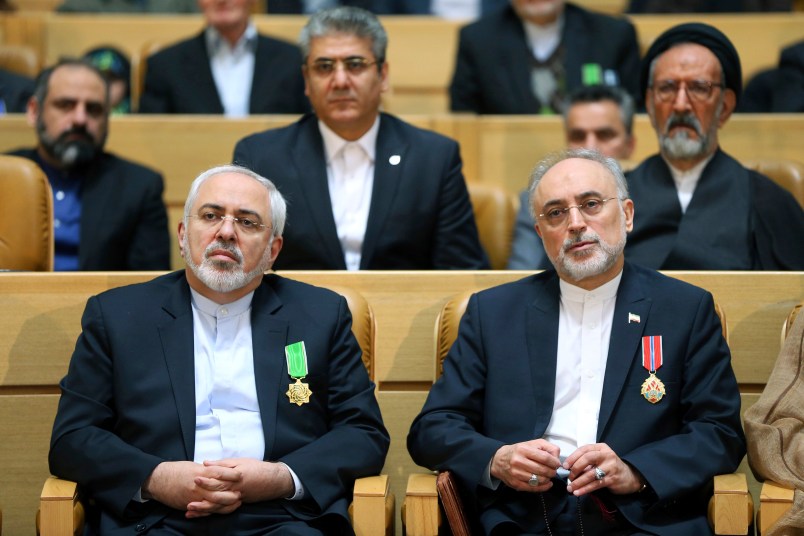 FILE-- In this file photo taken on Monday, Feb. 8, 2016, chief of Iran's Atomic Energy Organization Ali Akbar Salehi, right, sits next to Foreign Minister Mohammad Javad Zarif after being awarded medal of honor by President Hassan Rouhani during a ceremony in Tehran, Iran.  Iran's atomic chief warned Tuesday the Islamic Republic needs only five days to ramp up its uranium enrichment to 20 percent, a level at which the material could be used for a nuclear weapon. (AP Photo/Ebrahim Noroozi, File)