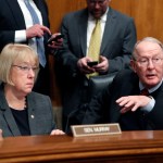 Senate Health, Education, Labor, and Pensions Committee Chairman Sen. Lamar Alexander, R-Tenn., accompanied by the committee's ranking member Sen. Patty Murray, D-Wash. speaks on Capitol Hill in Washington, Tuesday, Jan. 31, 2107, during the committee's executive session to discuss the nomination of Education Secretary-designate Betsy DeVos.  (AP Photo/Alex Brandon)