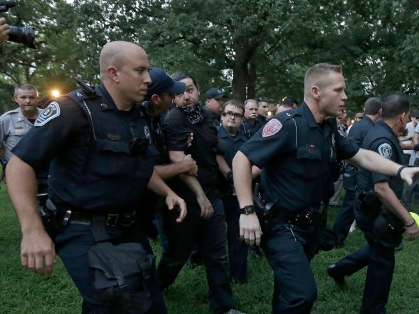 Police arrest a man during a protest at a Confederate monument at the University of North Carolina in Chapel Hill, N.C., Tuesday, Aug. 22, 2017. (AP Photo/Gerry Broome)
