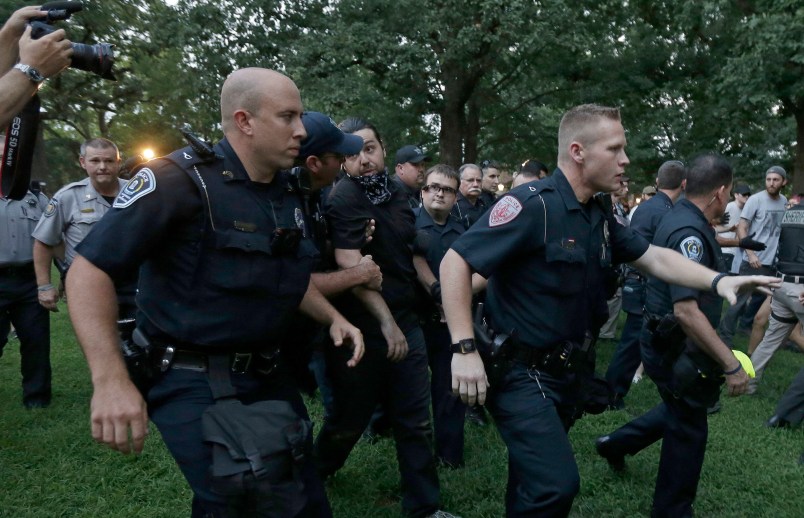 Police arrest a man during a protest at a Confederate monument at the University of North Carolina in Chapel Hill, N.C., Tuesday, Aug. 22, 2017. (AP Photo/Gerry Broome)