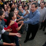 Cambodia's Prime Minister Hun Sen, center, greets garment workers during he takes a visit to Phnom Penh Special Economic Zone at the outskirts of Phnom Penh, Cambodia, Wednesday, Aug. 23, 2017. Hun Sen on Wednesday begun his plan to visit workers who work at the factories in widely Cambodia. (AP Photo/Heng Sinith)