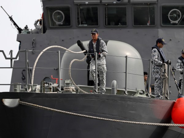 Sailors on the Republic of Singapore Navy's RSS Brave, casts off from a berth at Tuas naval base on a search and rescue mission for USS John S. McCain's 10 missing  sailors on Thursday, Aug. 24, 2017 in Singapore. Aircraft and ships from the navies of Singapore, Malaysia, Indonesia and Australia are searching seas east of Singapore where the collision between USS John S. McCain and an oil tanker happened early Monday. (AP Photo/Wong Maye-E)