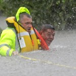 Wilford Martinez, right, is rescued from his flooded car along Interstate 610 in floodwaters from Tropical Storm Harvey Sunday, Aug. 27, 2017, in Houston, Texas. (AP Photo/David J. Phillip)