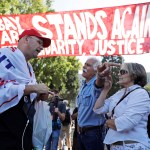 Donald Trump supporter Arthur Schaper, left, argues his position with Mustafa Payrvand, center, and Christina Tunnah during a free speech rally Sunday, Aug. 27, 2017, in Berkeley, Calif. (AP Photo/Marcio Jose Sanchez)