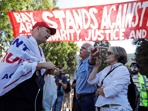 Donald Trump supporter Arthur Schaper, left, argues his position with Mustafa Payrvand, center, and Christina Tunnah during a free speech rally Sunday, Aug. 27, 2017, in Berkeley, Calif. (AP Photo/Marcio Jose Sanchez)