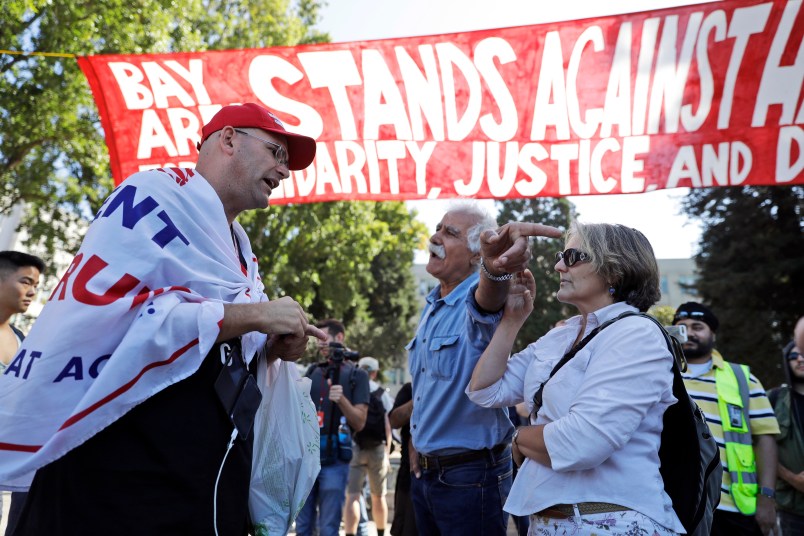 Donald Trump supporter Arthur Schaper, left, argues his position with Mustafa Payrvand, center, and Christina Tunnah during a free speech rally Sunday, Aug. 27, 2017, in Berkeley, Calif. (AP Photo/Marcio Jose Sanchez)