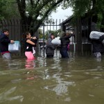 Residents from Bayou Parc at Oak Forest carry their belongings while evacuating the apartment complex during the Tropical Storm Harvey, Sunday, Aug. 27, 2017, in Houston. ( Marie D. De Jesus / Houston Chronicle )