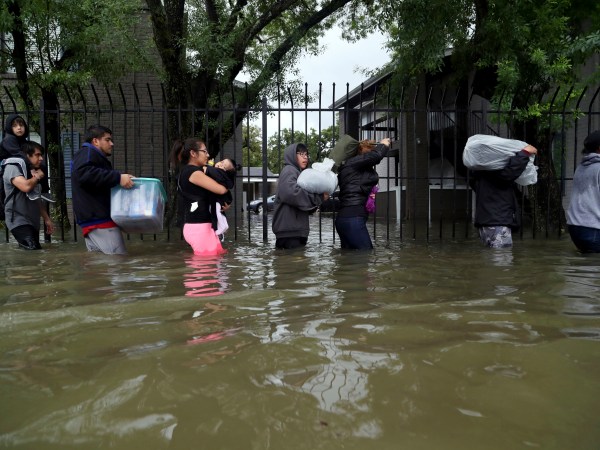 Residents from Bayou Parc at Oak Forest carry their belongings while evacuating the apartment complex during the Tropical Storm Harvey, Sunday, Aug. 27, 2017, in Houston. ( Marie D. De Jesus / Houston Chronicle )