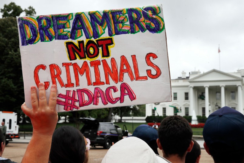 A woman holds up a signs in support of the Obama administration program known as Deferred Action for Childhood Arrivals, or DACA, during an immigration reform rally, Tuesday, Aug. 15, 2017, at the White House in Washington. The Trump administration has said it still has not decided the program's fate. (AP Photo/Jacquelyn Martin)