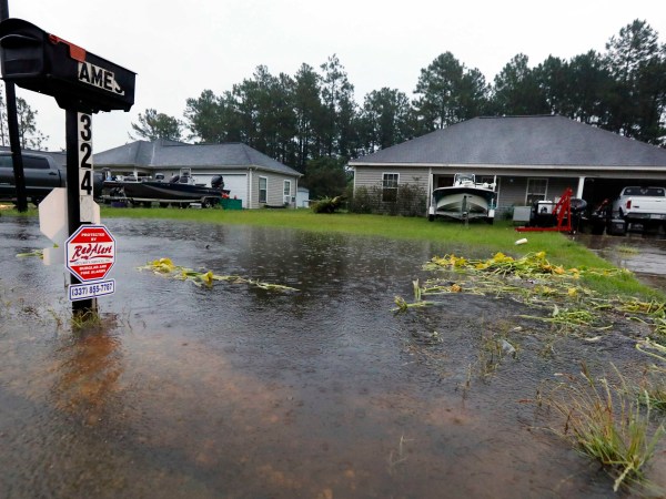 Rising waters threaten these homes along North Perkins Ferry Road in Moss Bluff, La., near Lake Charles, La., as a constant rain from Tropical Storm Harvey falls, Monday, Aug. 28, 2017. (AP Photo/Rogelio V. Solis)