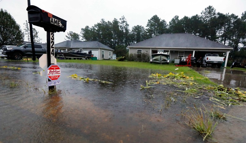 Rising waters threaten these homes along North Perkins Ferry Road in Moss Bluff, La., near Lake Charles, La., as a constant rain from Tropical Storm Harvey falls, Monday, Aug. 28, 2017. (AP Photo/Rogelio V. Solis)