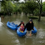 People evacuate a neighborhood in west Houston inundated by floodwaters from Tropical Storm Harvey on Monday, Aug. 28, 2017, in Houston, Texas. (AP Photo/Charlie Riedel)
