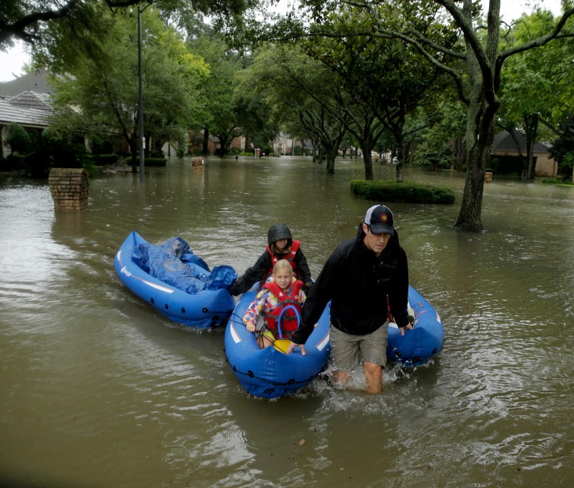 People evacuate a neighborhood in west Houston inundated by floodwaters from Tropical Storm Harvey on Monday, Aug. 28, 2017, in Houston, Texas. (AP Photo/Charlie Riedel)