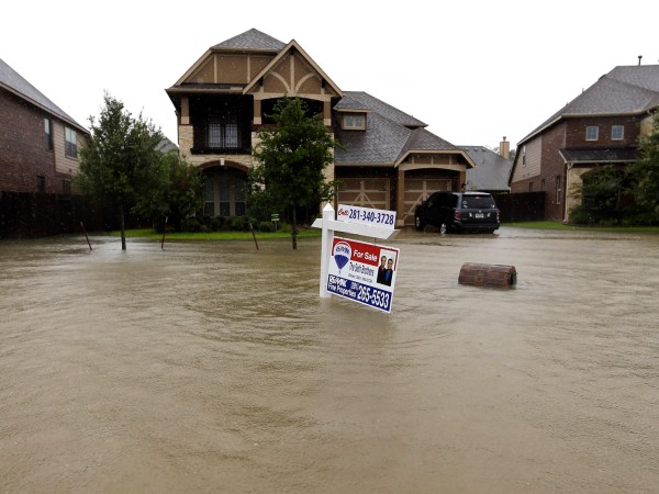A for sale signs stands in front of a home as floodwaters from Tropical Storm Harvey rise Monday, Aug. 28, 2017, in Spring, Texas. (AP Photo/David J. Phillip)