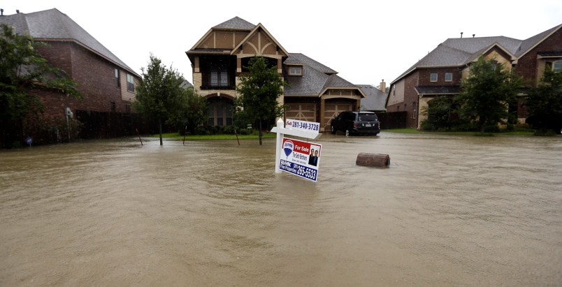A for sale signs stands in front of a home as floodwaters from Tropical Storm Harvey rise Monday, Aug. 28, 2017, in Spring, Texas. (AP Photo/David J. Phillip)