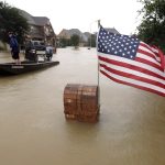 Volunteers use their boat to help evacuate residents as floodwaters from Tropical Storm Harvey rise Monday, Aug. 28, 2017, in Spring, Texas. (AP Photo/David J. Phillip)