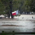 A Texas flag flies in flood waters caused by Hurricane Harvey. La Grange, TX. in Fayette County endured historic flooding when the Colorado River crested over flood stage at more than 53 feet Monday August 28, 2017. City streets and businesses were completely under water and some neighborhoods remain uninhabitable for the foreseeable future.RALPH BARRERA / AMERICAN-STATESMAN