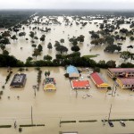 Water from Addicks Reservoir flows into neighborhoods as floodwaters from Tropical Storm Harvey rise Tuesday, Aug. 29, 2017, in Houston. (AP Photo/David J. Phillip)