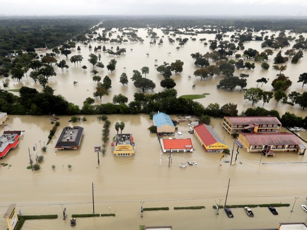 Water from Addicks Reservoir flows into neighborhoods as floodwaters from Tropical Storm Harvey rise Tuesday, Aug. 29, 2017, in Houston. (AP Photo/David J. Phillip)