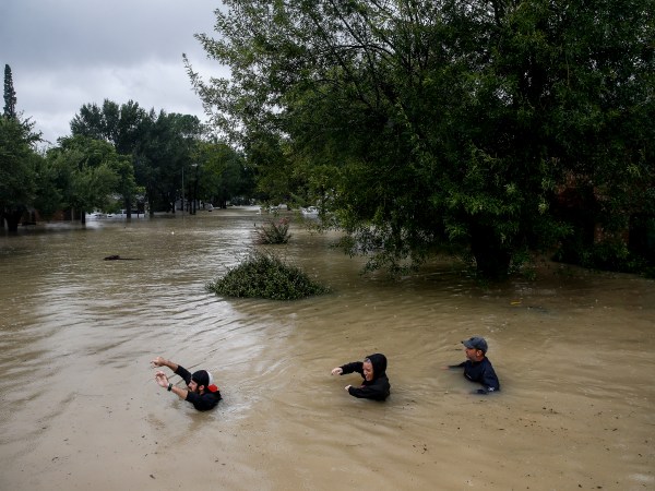 People wade through chest deep water down Pine Cliff Drive as Addicks Reservoir nears capacity due to near constant rain from Tropical Storm Harvey Tuesday, Aug. 29, 2017 in Houston. ( Michael Ciaglo / Houston Chronicle)
