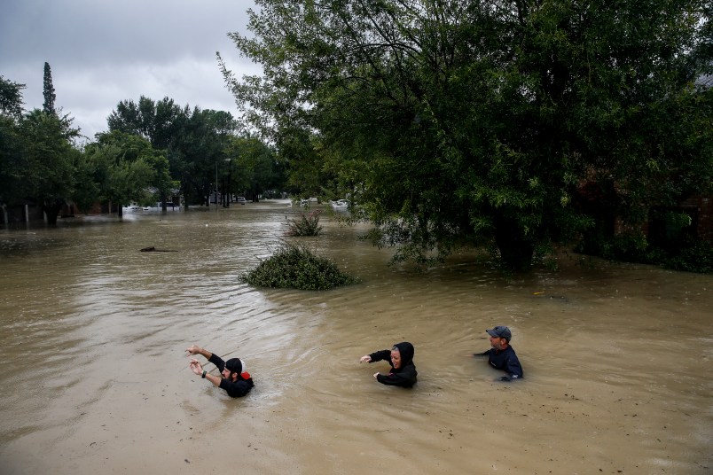 People wade through chest deep water down Pine Cliff Drive as Addicks Reservoir nears capacity due to near constant rain from Tropical Storm Harvey Tuesday, Aug. 29, 2017 in Houston. ( Michael Ciaglo / Houston Chronicle)