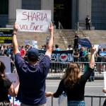 Demonstrators gathered to protest against Islamic law, foreground, stand across from counter demonstrators Saturday, June 10, 2017, in New York. In more than two dozen cities across the United States, the group organizing the rallies, ACT for America, is speaking out against Shariah law, saying it is incompatible with Western democracy and the freedoms it affords. (AP Photo/Craig Ruttle)