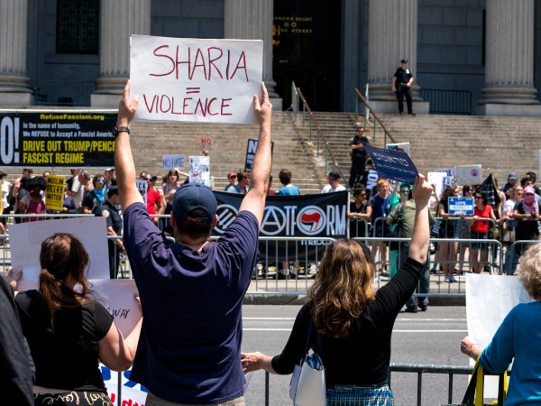 Demonstrators gathered to protest against Islamic law, foreground, stand across from counter demonstrators Saturday, June 10, 2017, in New York. In more than two dozen cities across the United States, the group organizing the rallies, ACT for America, is speaking out against Shariah law, saying it is incompatible with Western democracy and the freedoms it affords. (AP Photo/Craig Ruttle)