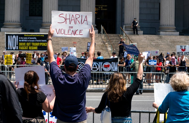 Demonstrators gathered to protest against Islamic law, foreground, stand across from counter demonstrators Saturday, June 10, 2017, in New York. In more than two dozen cities across the United States, the group organizing the rallies, ACT for America, is speaking out against Shariah law, saying it is incompatible with Western democracy and the freedoms it affords. (AP Photo/Craig Ruttle)