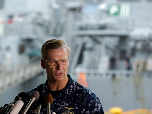 Vice Adm. Joseph Aucoin, Commander, U.S. 7th Fleet, speaks during a press conference with damaged USS Fitzgerald as background at the U.S. Naval base in Yokosuka, southwest of Tokyo Sunday, June 18, 2017. (AP Photo/Eugene Hoshiko)