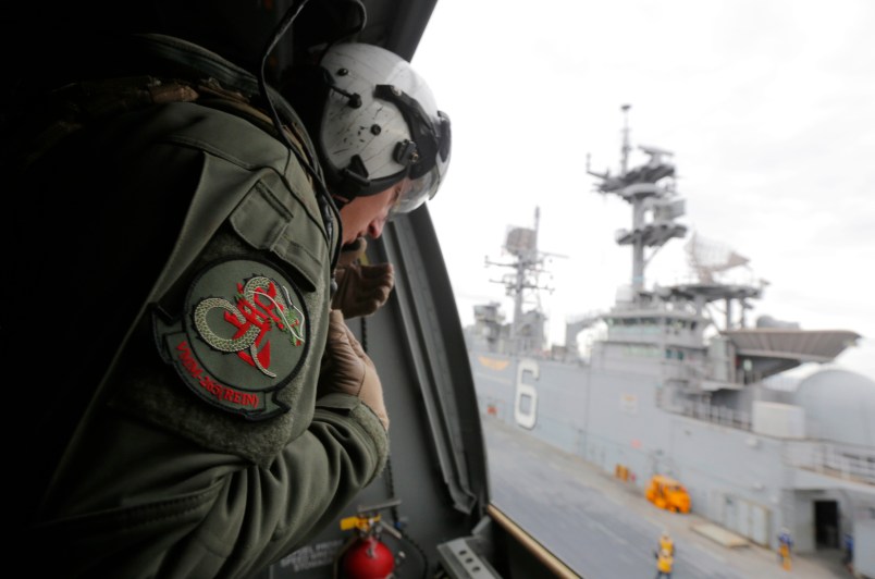 A crewman aboard a U.S. Marine MV-22B Osprey Aircraft looks out as it lifts off the deck of the USS Bonhomme Richard amphibious assault ship off the coast of Sydney, Australia, Thursday, June 29, 2017 after a ceremony on board the ship marking the start of Talisman Saber 2017, a biennial joint military exercise between the United States and Australia. (Jason Reed/Pool via AP)
