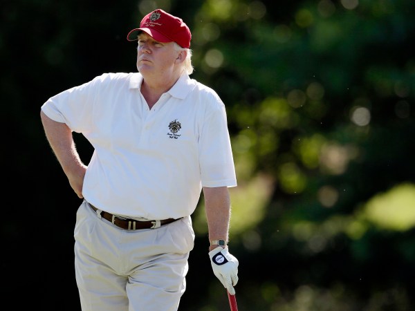 FILE - In this June 27, 2012, file photo, Donald Trump stands on the 14th fairway during a pro-am round of the AT&T National golf tournament at Congressional Country Club in Bethesda, Md. A set of golf clubs that Donald Trump gifted to a former caddie before becoming president is being auctioned off. Boston-based RR Auction says Trump used the TaylorMade RAC TP ForgedIrons clubs at the Trump National Golf Club in Bedminster, New Jersey. (AP Photo/Patrick Semansky, File)