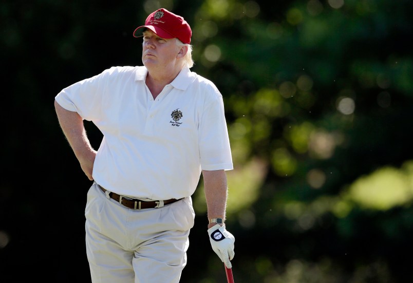 FILE - In this June 27, 2012, file photo, Donald Trump stands on the 14th fairway during a pro-am round of the AT&T National golf tournament at Congressional Country Club in Bethesda, Md. A set of golf clubs that Donald Trump gifted to a former caddie before becoming president is being auctioned off. Boston-based RR Auction says Trump used the TaylorMade RAC TP ForgedIrons clubs at the Trump National Golf Club in Bedminster, New Jersey. (AP Photo/Patrick Semansky, File)