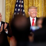 President Donald Trump, accompanied by Vice President Mike Pence, smiles before speaking in the East Room of the White House, Wednesday, July 26, 2017, in Washington. Trump is announcing the first U.S. assembly plant for electronics giant Foxconn in a project that's expected to result in billions of dollars in investment in the state and create thousands of jobs. (AP Photo/Alex Brandon)