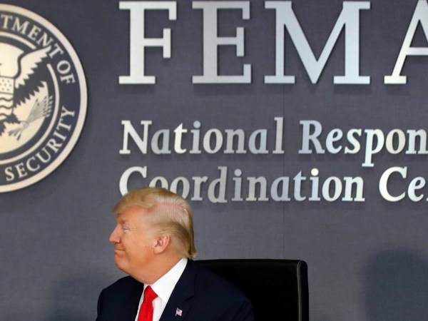 President Donald Trump turns to Vice President Mike Pence as they meet with emergency officials to discuss the hurricane season, Friday, Aug. 4, 2017, at Federal Emergency Management Agency (FEMA) headquarters in Washington. (AP Photo/Jacquelyn Martin)