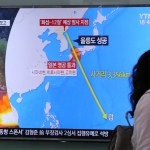 A woman passes by a TV screen showing a local news program reporting on North Korea threatens to strike Guam with ballistic missiles at the Seoul Train Station in Seoul, South Korea, Thursday, Aug. 10, 2017.  North Korea has announced a detailed plan to launch a salvo of ballistic missiles toward the U.S. Pacific territory of Guam, a major military hub and home to U.S. bombers. If carried out, it would be the North’s most provocative missile launch to date. The signs at left top read " North Korea announced a plan to launch a salvo of ballistic missiles toward the Guam. (AP Photo/Ahn Young-Joon)