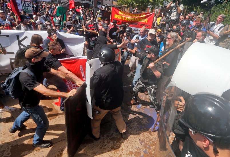 Alt Right demonstrators clash with  counter demonstrators at the entrance to Lee Park in Charlottesville, Va., Saturday, Aug. 12, 2017.  (AP Photo/Steve Helber)