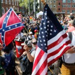 Alt Right demonstrators walk into Lee park surrounded by counter demonstrators in Charlottesville, Va., Saturday, Aug. 12, 2017.  (AP Photo/Steve Helber)