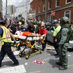 Rescue personnel help injured people after a car ran into a large group of protesters after an Alt Right rally in Charlottesville, Va., Saturday, Aug. 12, 2017.  (AP Photo/Steve Helber)