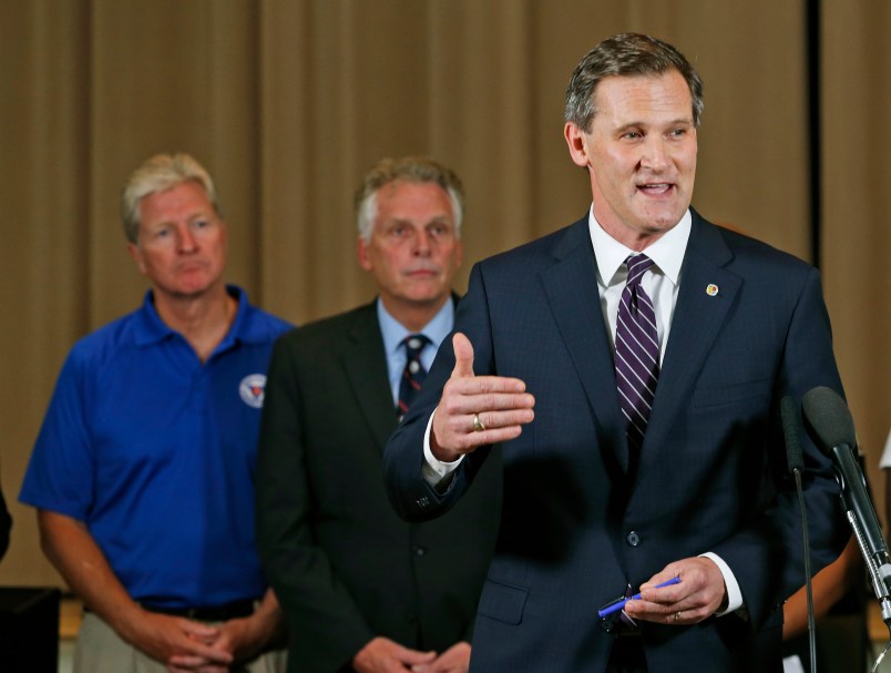 Charlottesville mayor, Mike Signer, right, gestures during a news conference as Virginia Gov. Terry McAuliffe, center, and Virginia Secretary of Public safety, Brian Moran,left, as  they address the the Alt Right rally and violence in Charlottesville, Va., Saturday, Aug. 12, 2017.  (AP Photo/Steve Helber)