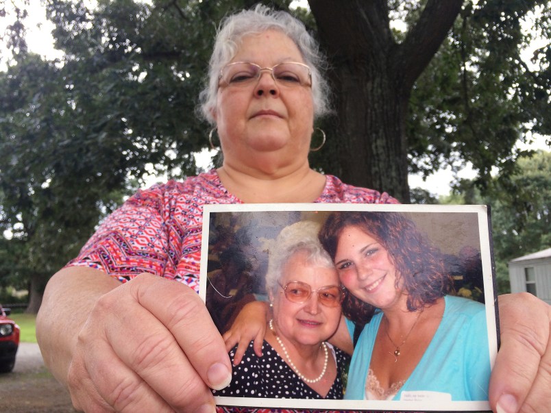 Susan Bro, the mother of Heather Heyer holds a photo of Susan's mother and her daughter, Monday, Aug. 14, 2017, in Charlottesville, Va.  Heyer was killed Saturday, Aug. 12, 2017, when police say a man plowed his car into a group of demonstrators protesting the white nationalist rally. Bro said that she is going to bare her soul to fight for the cause that her daughter died for. (AP Photo/Joshua Replogle)