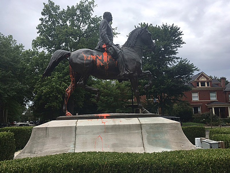 A statue of a Confederate officer is seen splattered with orange paint near a park in Louisville, Ky. on Monday, Aug. 14, 2017. The vandalism was discovered a day after violence erupted at a white nationalist rally in Charlottesville, Va. (AP Photo/Claire Galofaro)