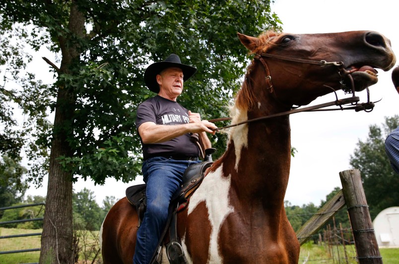Former Alabama Chief Justice and U.S. Senate candidate Roy Moore, rides in on a horse named "Sassy" to vote a the Gallant Volunteer Fire Department, during the Alabama Senate race, Tuesday, Aug. 15, 2017, in Gallant, Ala. (AP Photo/Brynn Anderson)