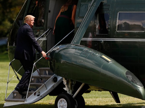 President Donald Trump boards Marine One with first lady Melania Trump on the South Lawn of the White House in Washington, Friday, Aug. 25, 2017, en route to Camp David, Md. (AP Photo/Carolyn Kaster)