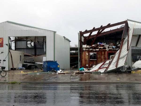 A cyclist passes buildings damaged in the wake of Hurricane Harvey, Saturday, Aug. 26, 2017, in Rockport, Texas. (AP Photo/Eric Gay)