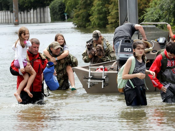 Residents are rescued from their homes surrounded by floodwaters from Tropical Storm Harvey Sunday, Aug. 27, 2017, in Houston, Texas. (AP Photo/David J. Phillip)