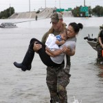 Houston Police SWAT officer Daryl Hudeck carries Connie Pham and her 13-month-old son Aiden after rescuing them from their home surrounded by floodwaters from Tropical Storm Harvey Sunday, Aug. 27, 2017, in Houston, Texas. (AP Photo/David J. Phillip)