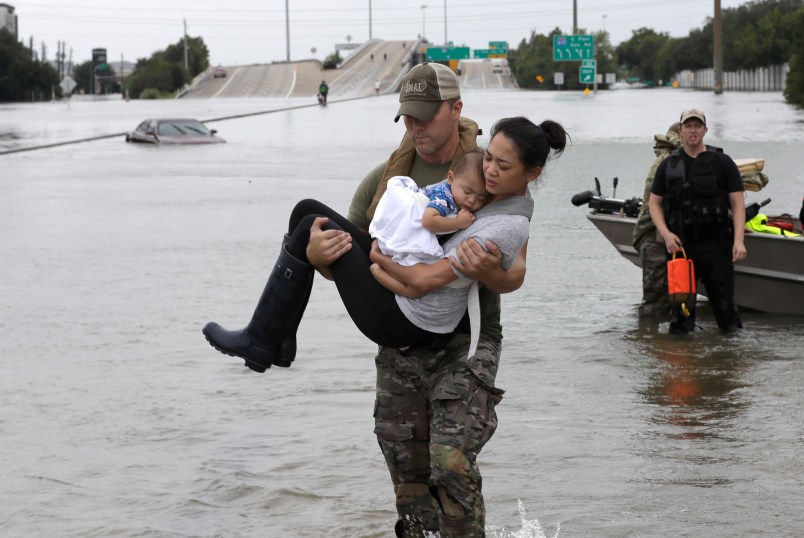 Houston Police SWAT officer Daryl Hudeck carries Connie Pham and her 13-month-old son Aiden after rescuing them from their home surrounded by floodwaters from Tropical Storm Harvey Sunday, Aug. 27, 2017, in Houston, Texas. (AP Photo/David J. Phillip)