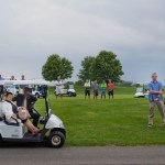 Golf club players join members of the White House Staff and security on the course as they all stop to listen to remarks from President Donald Trump at Trump National Golf Club in Bedminster, N.J., Friday, Aug. 11, 2017. (AP Photo/Pablo Martinez Monsivais)